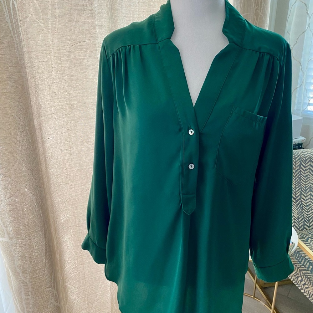 Ellison rich green color V-neck  blouse w/ front pocket and roll tab sleeves.